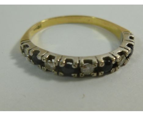 An 18 carat gold diamond and sapphire half eternity ring, the five round brilliant cut diamonds combined weight approximately