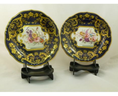 A pair of H & R Daniel porcelain plates, Cusped shape, with cobalt blue ground, gilt decoration and the central panel decorat