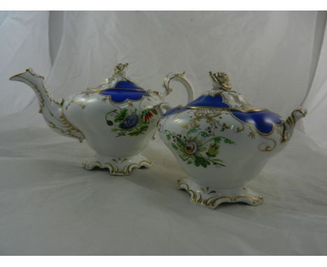 A 19th century English porcelain teapot and lidded sugar bowl with rose head finials, raised on quatrefoil scroll pedestals, 