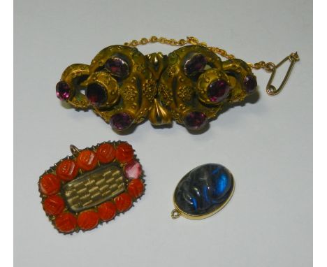 A Victorian hollow gold and garnet brooch, the eight oval and round mixed cut stones in closed foil back settings, with fine 