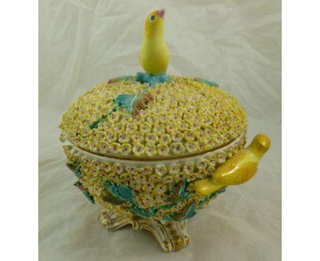 A Mintons Schneeballen style sucrier and cover with floral encrusted body, decorated in relief yellow birds and foliage, rais