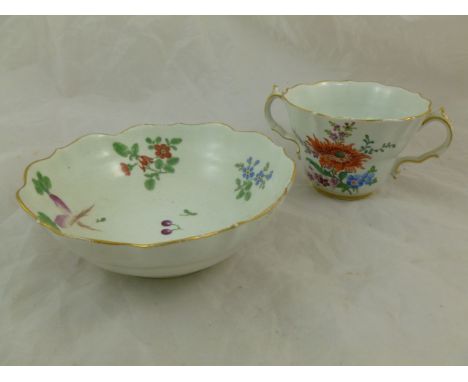 An 18th century Worcester porcelain chocolate cup and saucer, decorated in polychrome enamels with flowers, fruit and vegetab