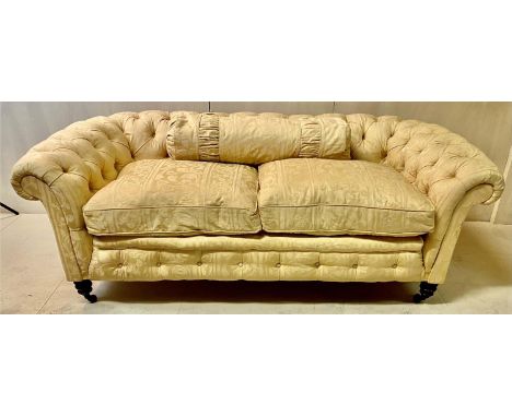 CHESTERFIELD TWO SEATER SOFA, early 20th Century, yellow damask floral patterned upholstery, deep buttoned, turned feet with 