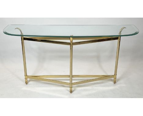 CONSOLE TABLE, vintage the bevel edged curved glass top, raised on a brass frame of triangular form, turned supports united b