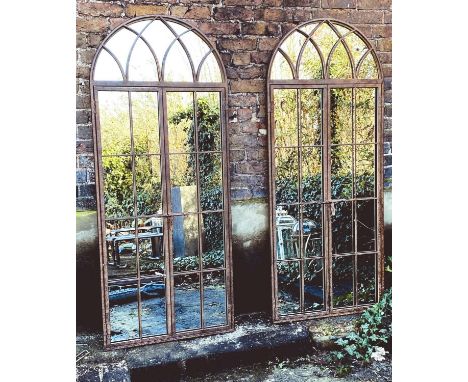 ARCHITECTURAL GARDEN GATED MIRRORS, a pair, Georgian style, aged metal frames, 180cm high, 76cm wide. (2) 