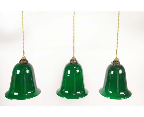 THREE GREEN BELL SHAPED PENDANT GLASS LIGHT SHADES, each measuring 28cm H shade and gallery, 63cm H drop, 25.5cm D. (3) 