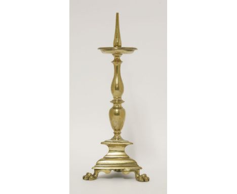 A Dutch pricket candlestick,c.1720, on a baluster turned column, triform base and paw feet,31cm high