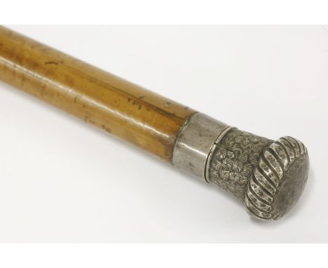 An Edwardian Macassar measuring stick,with an engraved silver handle and collar,90cm high