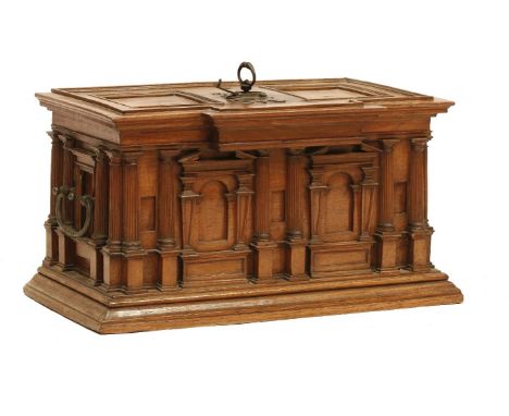 A rare German walnut casket,17th century, probably Augsburg, of architectural form, with Doric pillars flanking archways, on 