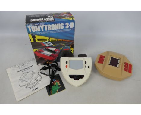 Tomy - Parker - 2 x vintage hand held games, a boxed Tomytronic 3-D Thundering Turbo # 7617. The item looks in Good condition