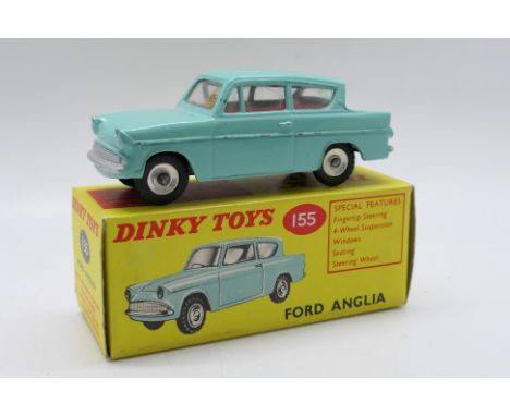 Dinky Toys - A boxed Dinky Toys #155 Ford Anglia. The model in turquoise with red interior has some paint rubs mainly along r