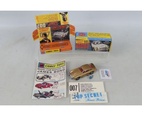 Corgi Toys - A boxed Corgi Toys #261 James Bond Aston Martins DB5. The original gold coloured vehicle comes with villain figu