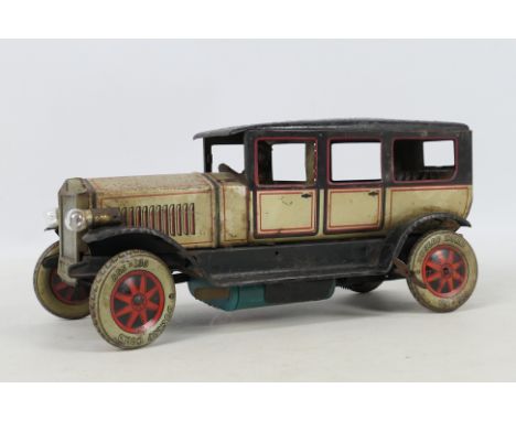Tipp &amp; Co - An unboxed 1930s German tinplate clockwork Tipp &amp; Co'TC950' limousine . The model in gold, black and red 