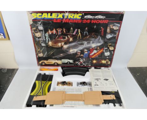 Scalextric - A boxed vintage Scalextric C664 Le Mans 24 Hour Set. The set contains 2x Porsche 935 in sliver and gold, track, 