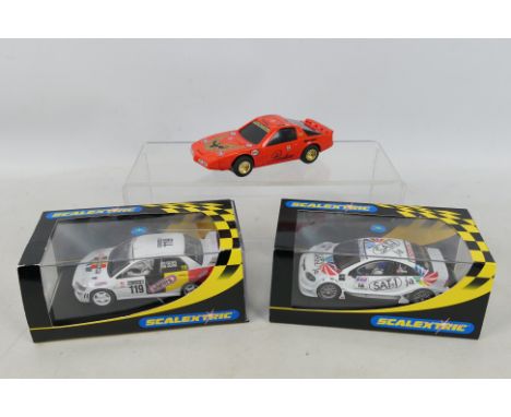 Scalextric - Two boxed and one unboxed Scalextric slot cars. Boxed cars include C2495 Mitsubishi Lancer Evolution 7 WRC 'FACO