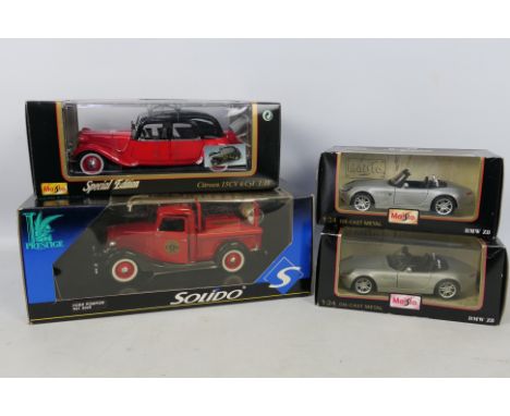 Solido - Maisto - Four boxed diecast model vehicles in 1:18 and 1:24 scales. Lot consists of Maisto 1:18 Special Edition Citr