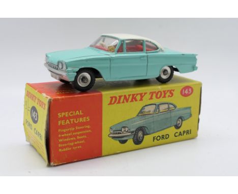 Dinky Toys - A boxed Dinky Toys #143 Ford Capri. The model in turquoise with white roof and red interior,  has some small nic