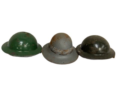 A group of three vintage helmets, one stencilled McEwan Brewers.&nbsp;