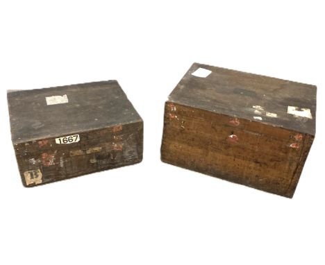 A traveling trunk with drop handles to side and travel labels, 42 x 75 x 54 cm, and another smaller, (2).&nbsp;