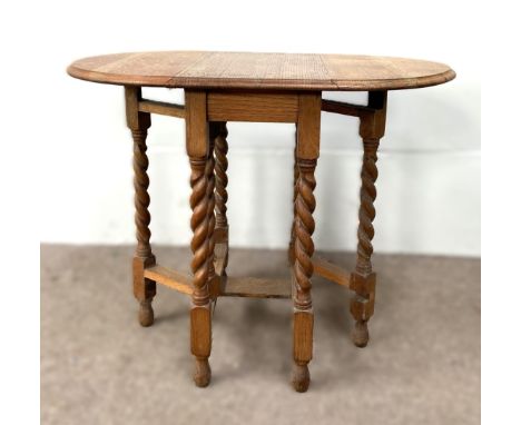 An oak gate leg table on spiral twist supports, 75 x 92 x 61 cm.