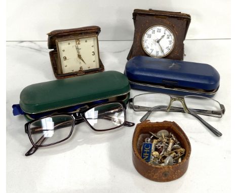 Two vintage travel clocks, two pairs of eye glasses, cufflinks, badges, etc.&nbsp;