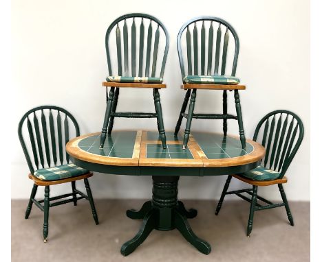 A tile topped extendable kitchen dining table on pedestal base with four matching dining chairs, table measures 75 x 145 x 10