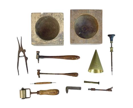 A collection of silversmithing tools. Including hammers, an archimedes drill and two treen swage blocks.