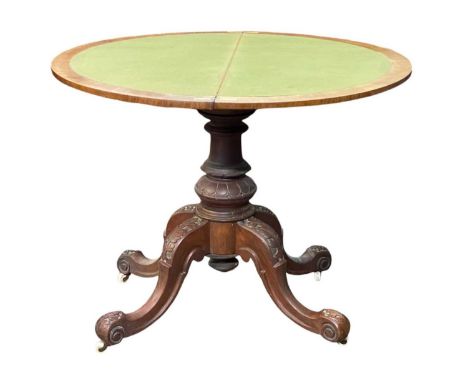 A Victorian burr walnut and inlaid half round card table. With a folding baize lined top on a stout turned and carved pillar 