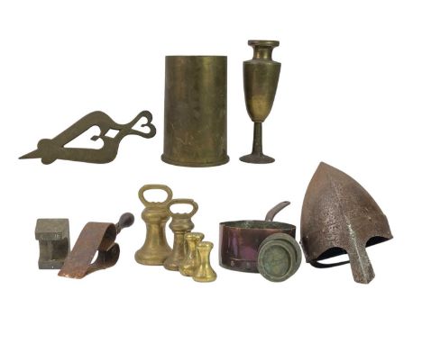 A collection of seven various brass weights. Two Victorian trivets, a 1943 brass shell case, a copper saucepan, and a re-enac