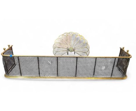 A Victorian brass fan shaped fire screen. Width 69cm, together with a large brass mesh fender, width 157cm (2).