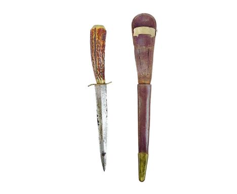 A WWII Fairburn Sykes FS type fighting knife. With an antler handle, in a leather scabbard, length 29cm.