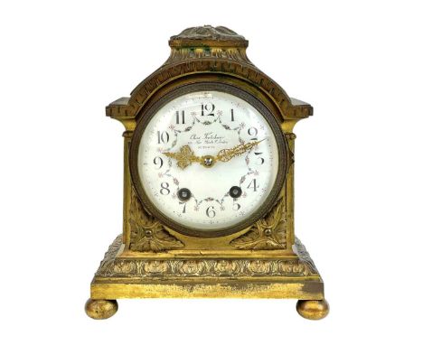 A French gilt bronze mantel clock, by Charles Frodsham. Late 19th century, the circular white dial with enamelled floral swag