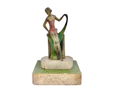 An Art Deco spelter strike table lighter. Modelled as a fashionable lady, with a coloured dress and scarf on a marble base, m