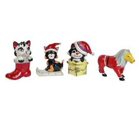 A Lorna Bailey pottery Christmas Cat. Riding on a toboggan, height 12cm together with two other Lorna Bailey Christmas Cats a