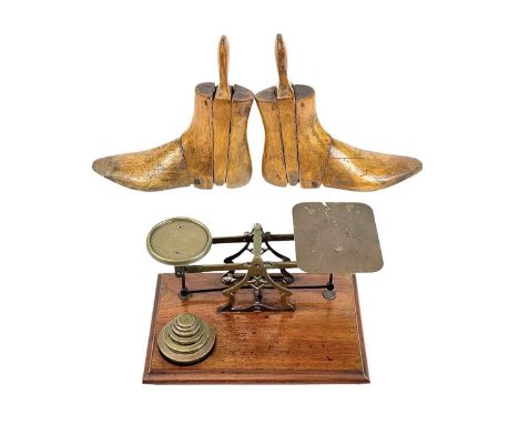 A set of Victorian mahogany and brass postal scales, by Avery. With weights, width 28.5cm, together with two treen shoe lasts