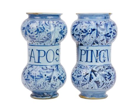 A matched pair of Italian Maiolica albarelli or dry drug jars.  Probably Venetian, early 17th century, of waisted form, the p
