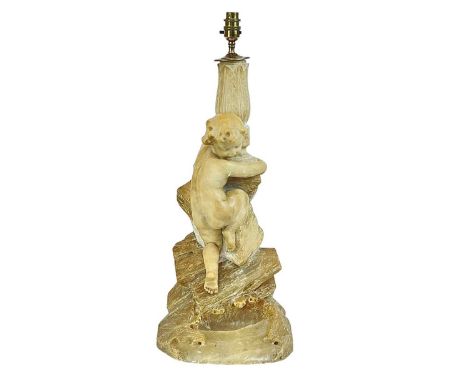 A large alabaster figural lamp of a boy climbing a cliff. Height 63cm