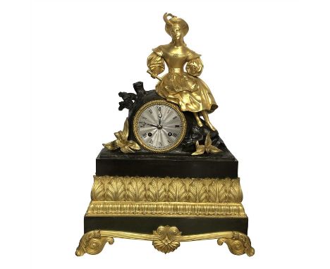 A French bronze and gilt metal mantel clock. Circa 1860, mounted a lady holding a scroll, with an engine turned dial and stif