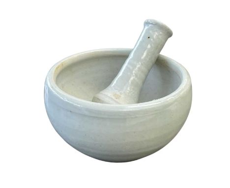 A Leach Pottery porcelain celadon glazed pestle and mortar. Impressed marks, diameter 12cm.
