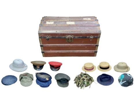 A Trunk of various military and other headwear. Comprising two boaters, two pith helmets, a US ballistic helmet, etc, the tru
