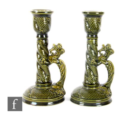 Wardle - A pair of late 19th Century candlesticks in the Aesthetic style, each with a dragon climbing the sconce, to form the