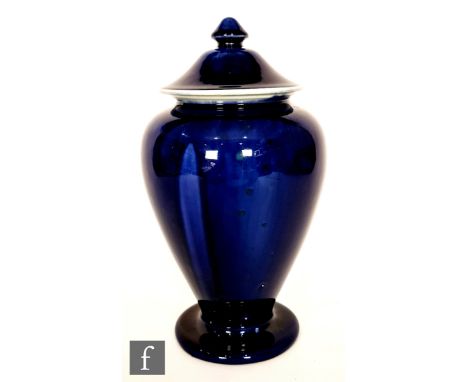 Ruskin Pottery - A large vase and cover decorated in an all over dark blue souffle glaze with faint patches and glaze runs, i