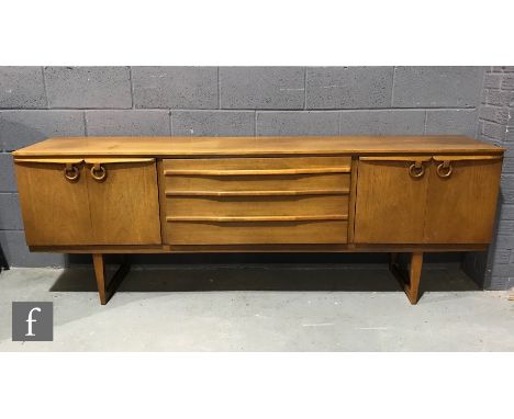 Beautility Furniture - A teak sideboard fitted with a central bank of three drawers and flanked by a double door cupboard wit