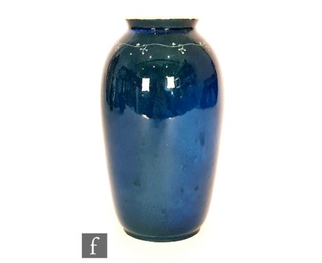 Ruskin Pottery - A souffle glaze vase decorated in a mottled green over dark blue with a hand painted garland to the shoulder