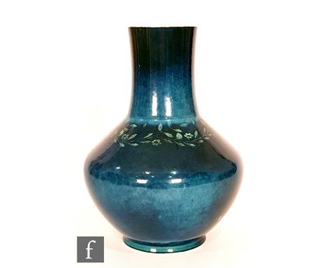 Ruskin Pottery - A souffle glazed vase of angular form with a cylinder neck decorated in a mottled green and blue glaze with 