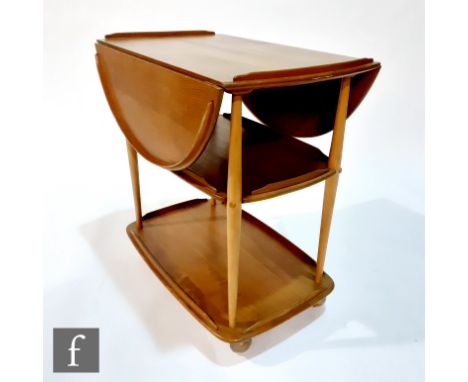 Lucian Ercolani - Ercol Furniture - A model 505 elm and beech table trolley, with an oval drop-leaf top and raised to swivel 