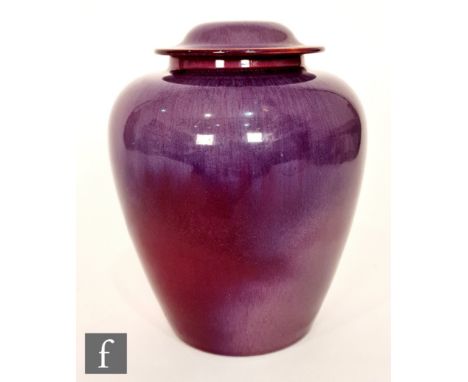 Ashby Potters Guild - An early 20th Century Arts and Crafts vase and cover, the tapering body decorated in a tonal purple wit