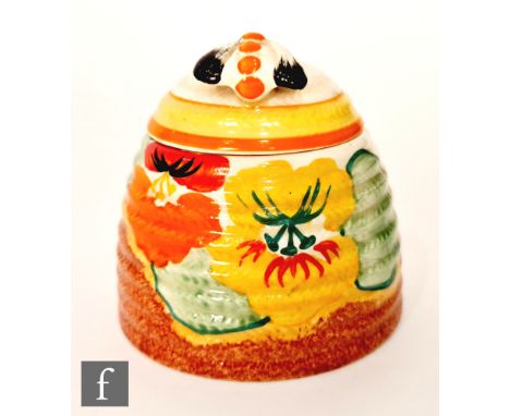 Clarice Cliff - Nasturtium -A large Bee Hive honey pot circa 1932, hand painted with stylised flowers and foliage over a stip