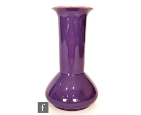 Ault Pottery - A 1920s Arts and Crafts vase of compressed globe and shaft form, the whole glazed in purple with a yellow crea