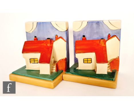 Clarice Cliff - Cottage - A pair of novelty book ends modelled as a stylised cottage picked out in enamel colours with red ro